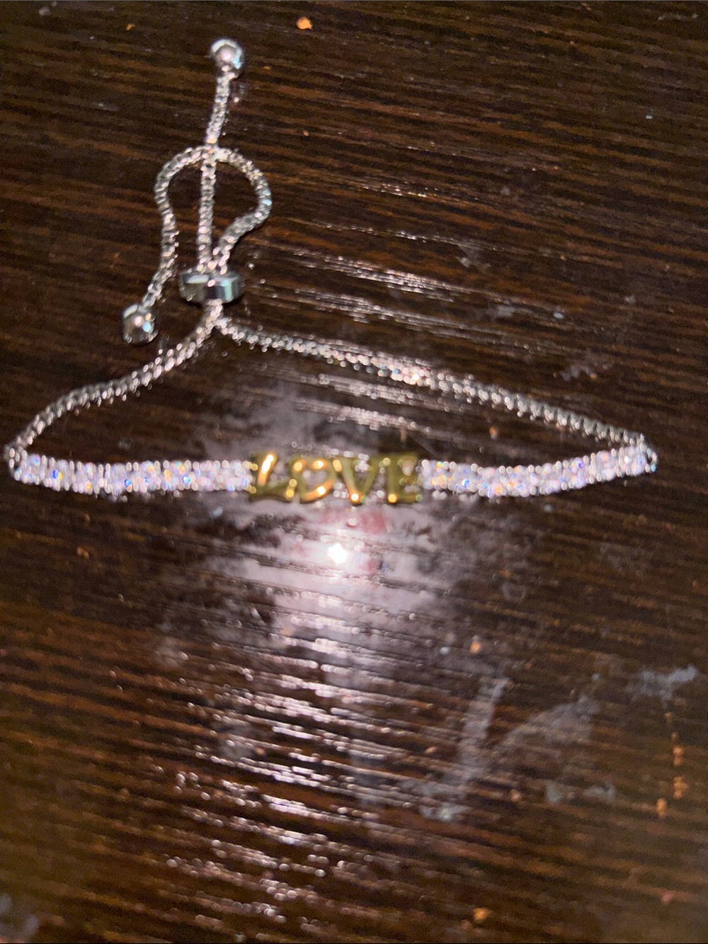 Adjustable Silver-Tone Bracelet with Gold LOVE Accent and Clear Stones